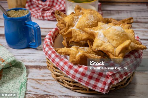 Typical Fried Sweet Potato And Quince Pastries On A Tray Accompanied By The Classic Mate On An Old Wooden Table Ethnic Or Regional Cuisine Concept Stock Photo - Download Image Now