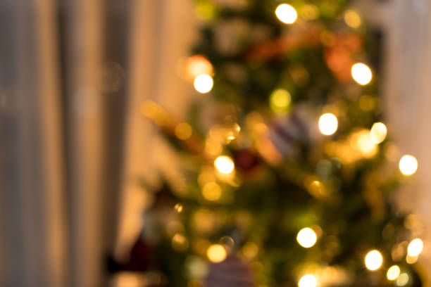 istock Blurred Christmas tree assembled with ornaments. Red, silver and gold balls, gift boxes, lights, Santa Claus and others. To insert something in front in focus 1345213973