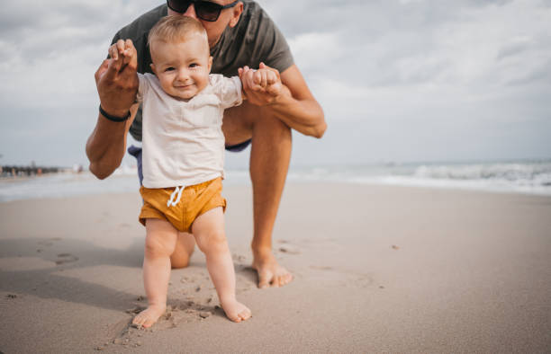 istock The father teaches the son the first steps on the beach 1345214843