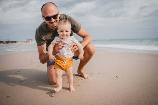 istock The father teaches the son the first steps on the beach 1345214953