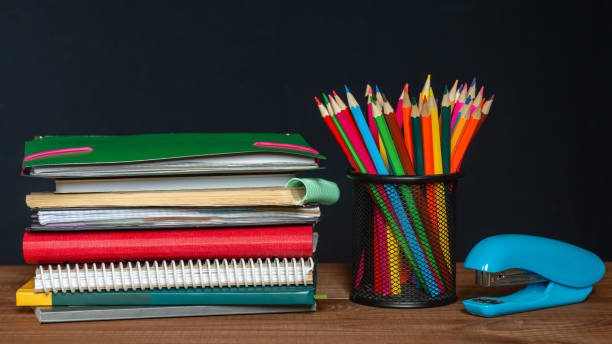 istock A stack of notebooks, a jar of pencils and a stapler on the table 1345215782