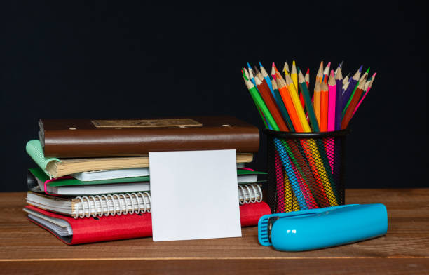 istock Sticker with space for text on the background of the educational installation. Textbooks, pencils. Learning concept 1345215848
