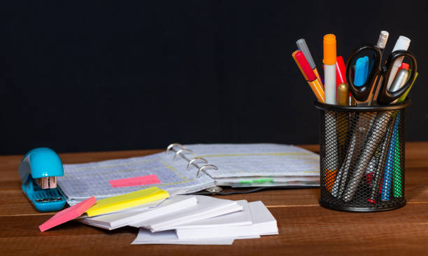 istock Open notebook with pencils in jar in a concept of primary education, design, creativity or art 1345215864
