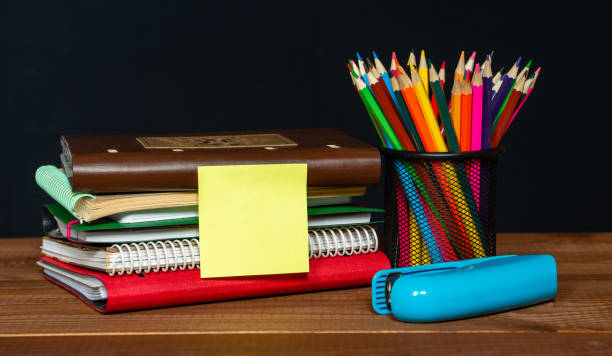 Sticker with space for text on the background of the educational installation. Textbooks, pencils. Learning concept