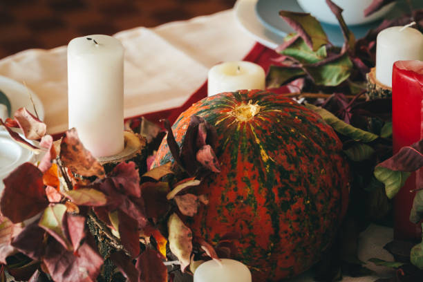 istock Fall thanksgiving decor with candle and pumpkins close up 1345215998