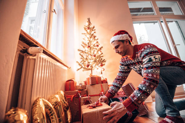 istock moving the christmas gifts under the christmas tree 1345217975