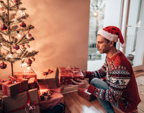 istock moving the christmas gifts under the christmas tree 1345218079