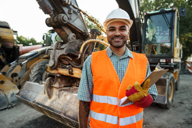 istock Young man engineer in workwear standing in construction site with clipboard 1345218182