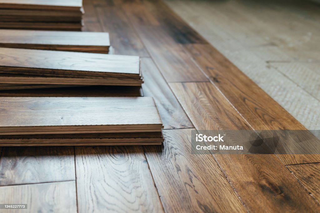 Solid oak wood flooring The process of house renovation with changing of the floor from carpets to solid oak wood. Beautiful golden handscraped oiled European oak brushed for added texture and fine definition of wood grain Flooring Stock Photo
