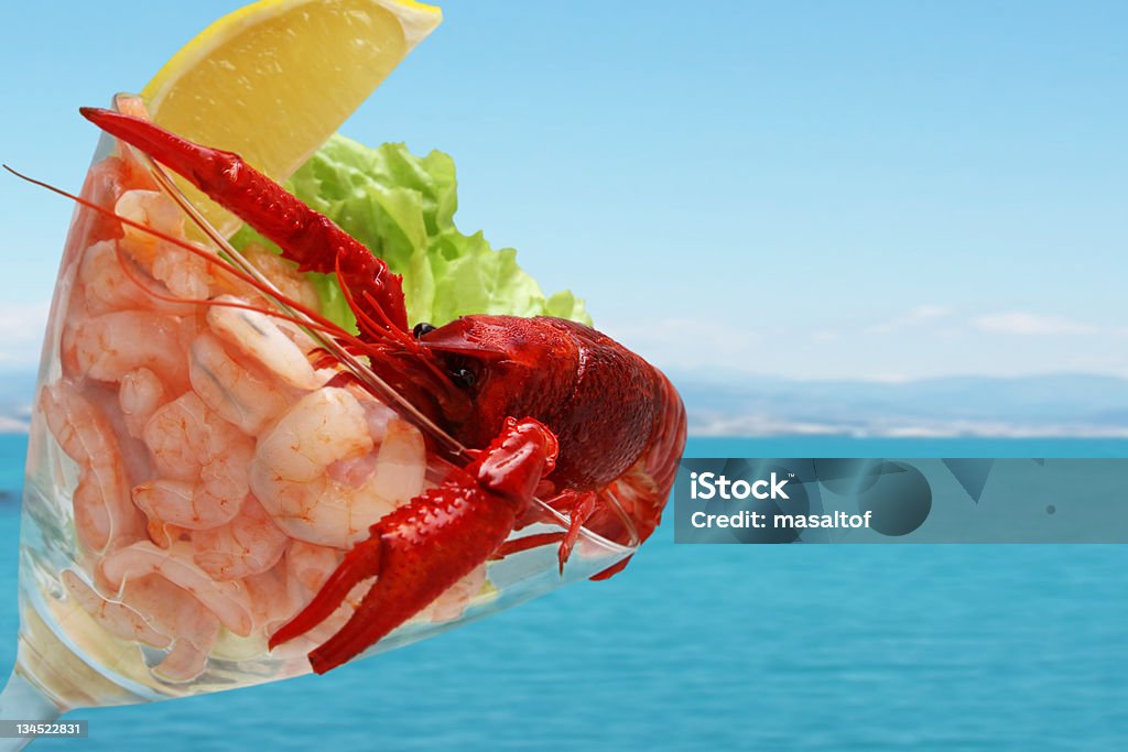 shrimp cocktail shrimp cocktail with crayfish in the glass on blue sea background Boiled Stock Photo