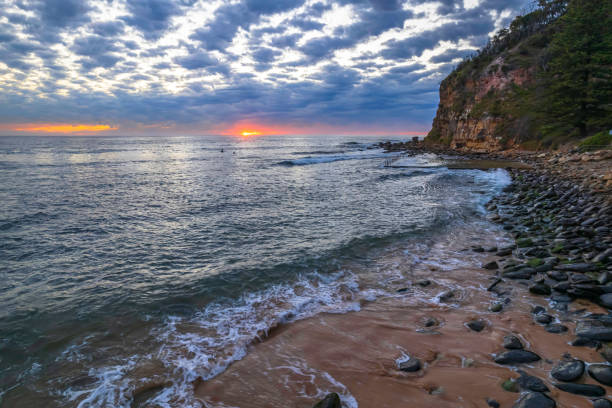 istock Sunrise at the seaside under a cloud filled sky 1345228747