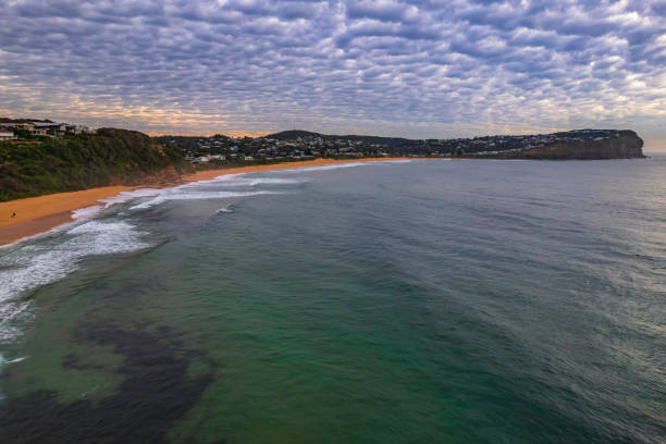 istock Sunrise at the seaside under a cloud filled sky 1345228859