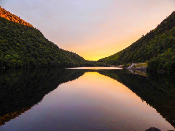 istock Pond reflecting trees and mountains in the water (Cascade lake) 1345228874