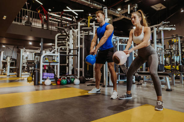 Gym Couple exercising in the gym health club stock pictures, royalty-free photos & images