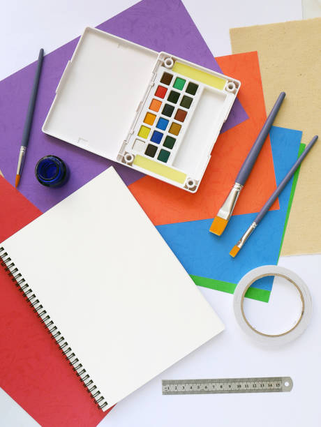istock Set of color water color, brushes, notebook on a creative background 1345229785