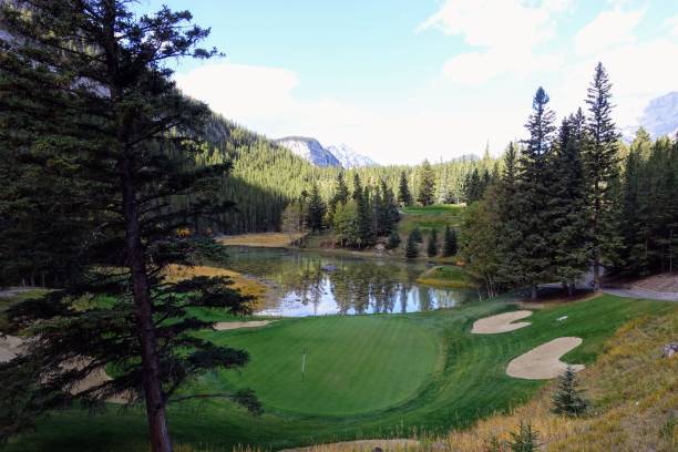 istock A beautiful view of a par 3 golf hole on a course with mountains in the background, surrounded by forest, on a beautiful sunny day with blue sky, in the rocky mountains near Banff, Alberta 1345230499
