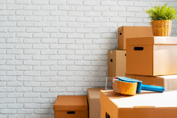 Close up of moving carton boxes in an empty room stock photo