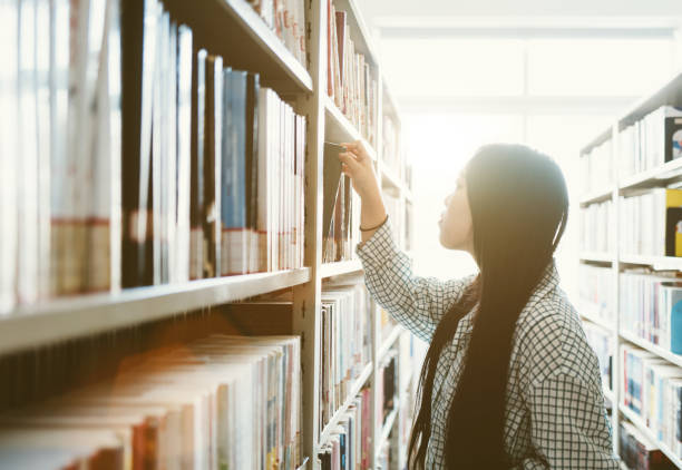 istock Girls in Library 1345230619