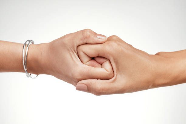 Concept of salvation. Image of the hands of two people at the time of rescue (help). Black and white.