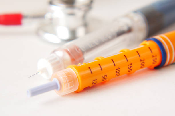 istock Insulin pens and stethoscope on while background, close up 1345235035