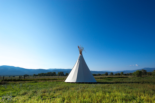 Taos, NM: White Teepee Against Vibrant Blue Sky