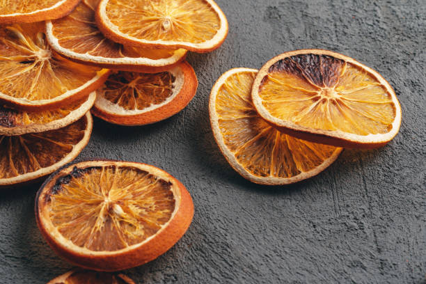 istock Dry orange slices on dark grey background 1345237745