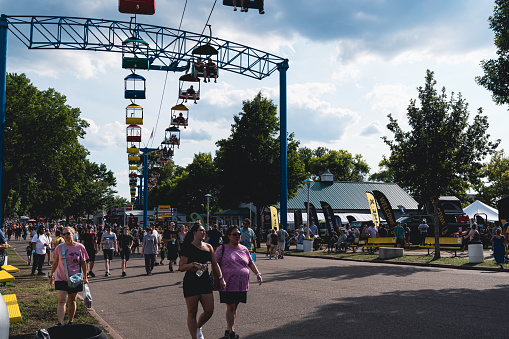St. Paul, Minnesota - August 30, 2021: People enjoy the Minnesota State Fair, walking around, near the sky ride