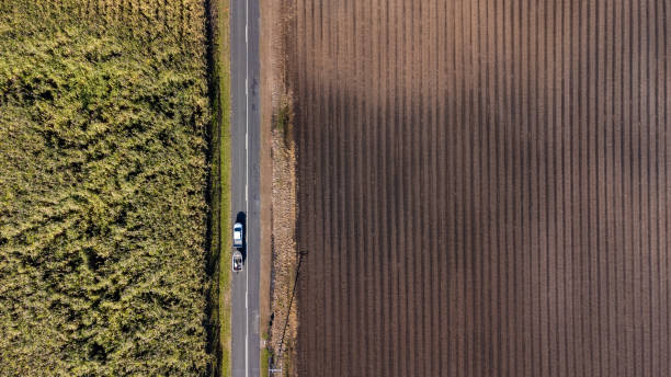 Drone shot of car towing a boat on rural road in regional Australia stock photo