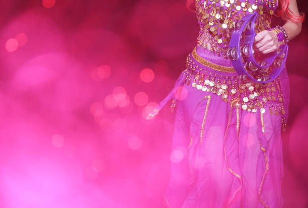 Belly Dancer wearing purple dance costume close up with bokeh stock photo