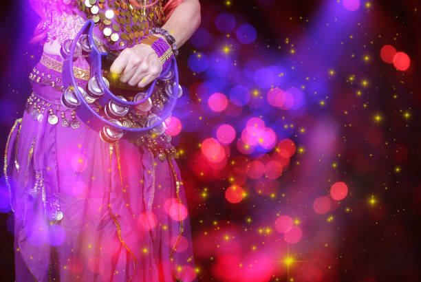 Belly Dancer wearing purple dance costume close up with bokeh stock photo