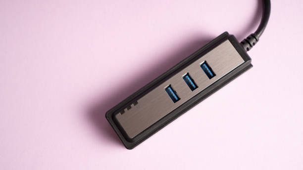 istock Multiple USB hub isolated on purple. Three ports USB charger 1345245492