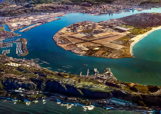A spectacular overview from an airplane of San Diego, San Diego Bay, the Coronado Bridge, Naval Air Station North Island and surrounding area.