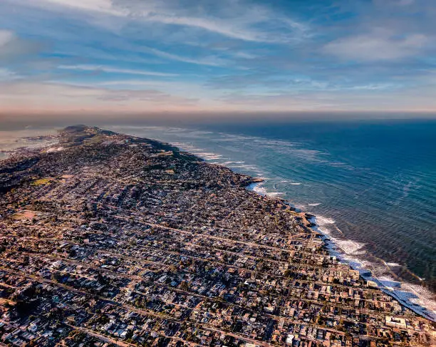 A beautiful  view from an airplane of the San Diego coastline with breaking waves at dawn.