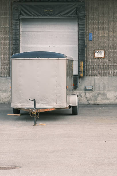 istock Cargo trailer parked in front of factory Loading bay 1345254003