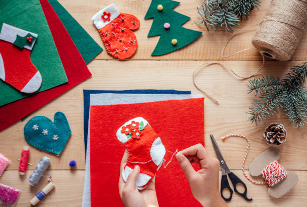 istock Child's hand holding handmade Christmas felt stocking 1345255035