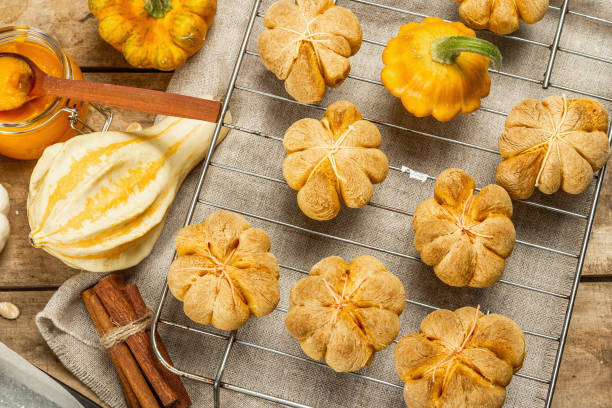 istock Pumpkin buns or cookies, traditional fall baked goods. Making biscuits process 1345255083