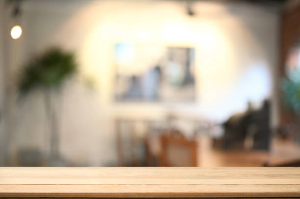 istock Empty wooden table with blurred living room in background. Copy space for your text message or information content. 1345256835