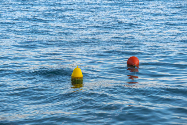 Red and yellow bouy floating on the sea.