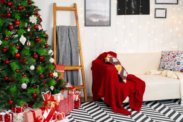 istock Beautifully decorated Christmas room with fir tree and white sofa 1345257307