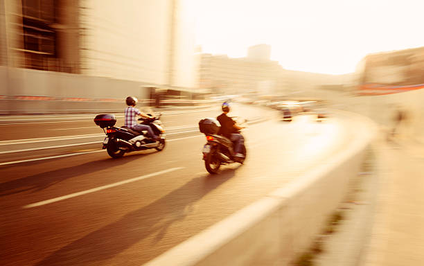 istock Men Drive Fast Scooters on Milan 's Streets 134525731