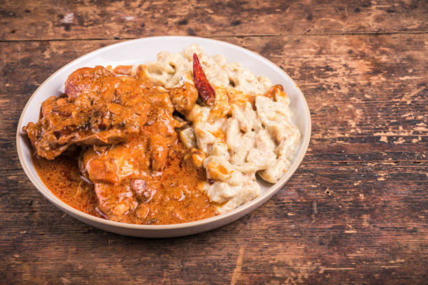 Chicken stew with paprika and cream in a plate with homemade gnocchi, copy space for recipe, chicken paprikash, hungarian cuisine Chicken stew with paprika and cream in a plate with homemade gnocchi, copy space for recipe, chicken paprikash, hungarian cuisine hungarian culture stock pictures, royalty-free photos & images