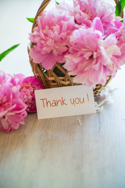istock several branches of blooming pink peonies on a wooden table 1345260143