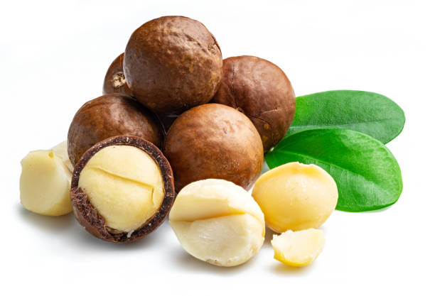 istock Macadamia nuts with peeled macadamia and leaves isolated on a white background. 1345260485
