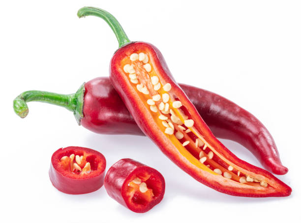 istock Fresh red chilli pepper and cross sections of chilli pepper with seeds isolated on white background. 1345260738