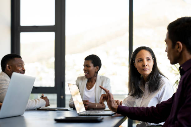 istock Employee engagement breakout groups around a boardroom table 1345260832