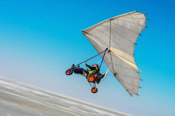 Pilot woman hand glider before start.