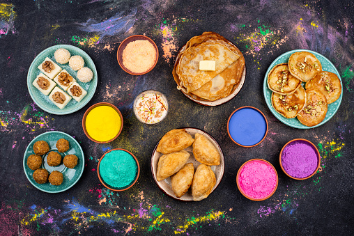 Traditional Indian festival food and gulal colors. Happy Holi concept.