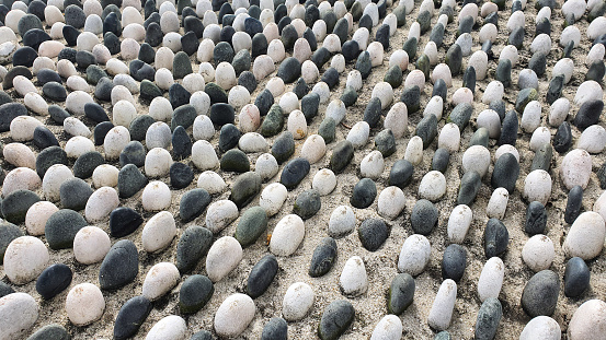 Beach pebbles are sediments. Beach pebbles can be composed of any type of rock (granite, basalt, marble, rhyolite. sandstone).