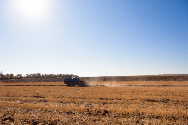 istock Farmer preparing his field in a tractor ready for spring. 1345265457