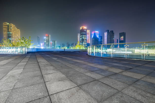 istock night view of empty brick floor front of modern building 1345266305